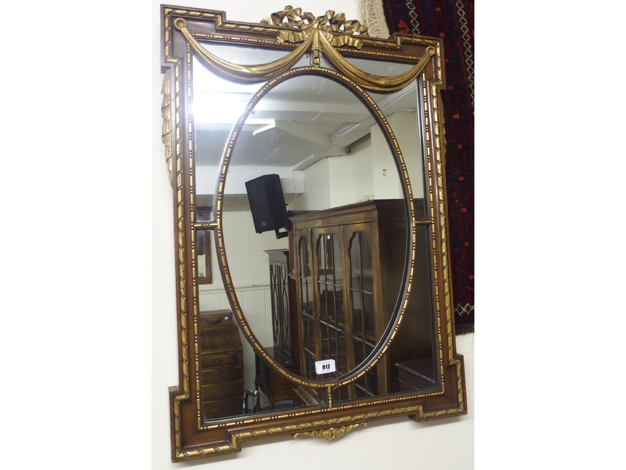 Appraisal: A walnut mirror with gilt swags and tails