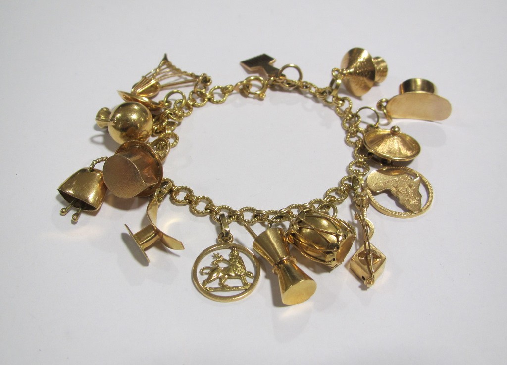 Appraisal: Eighteen carat gold charm bracelet with various mid sized charms