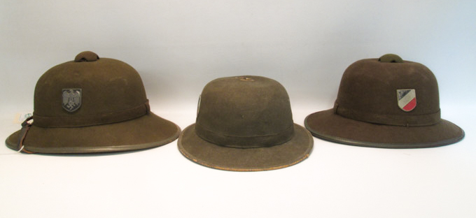 Appraisal: THREE GERMAN WORLD WAR TWO STYLE PITH HELMETS green felt