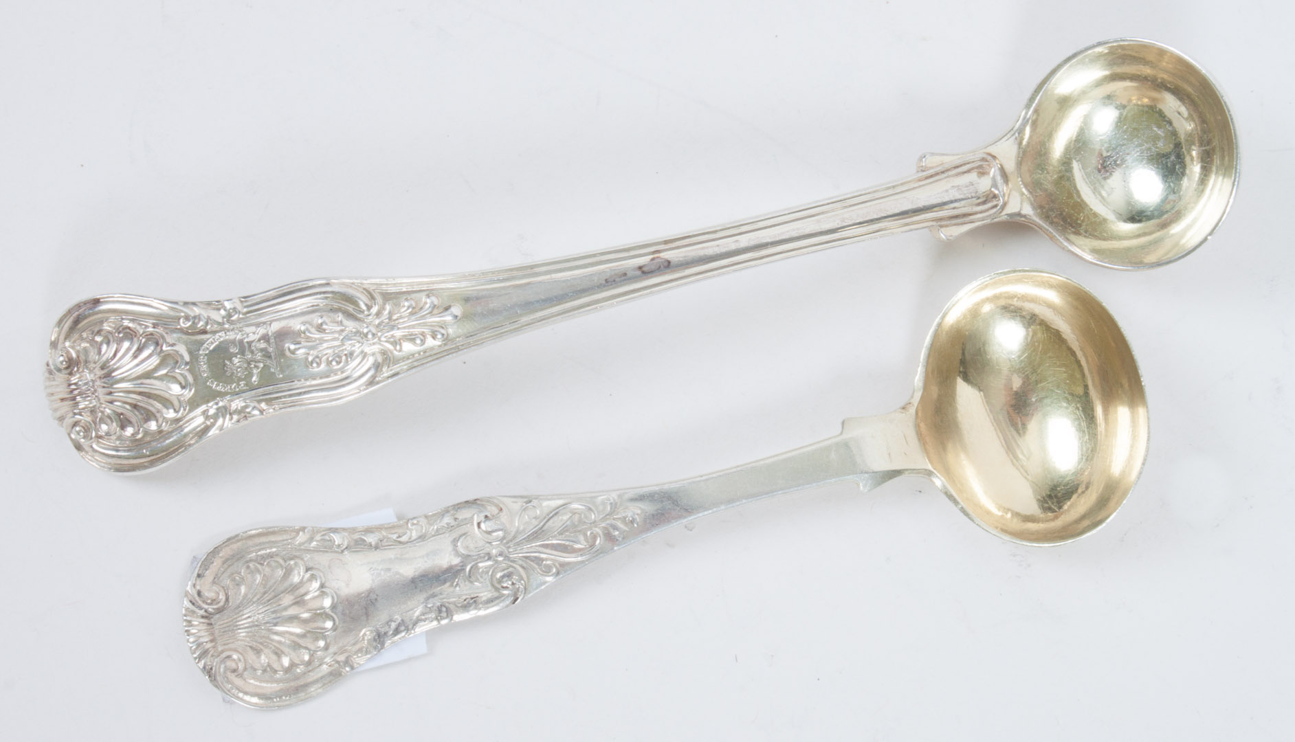 Appraisal: Two George IV sterling silver condiment spoons in the King's