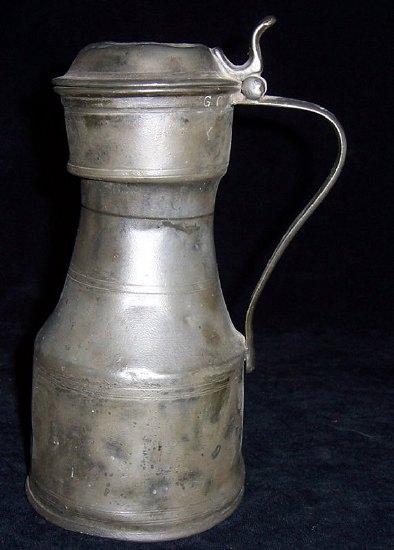 Appraisal: A pewter tapit-hen the hinged cover with scroll thumbpiece and