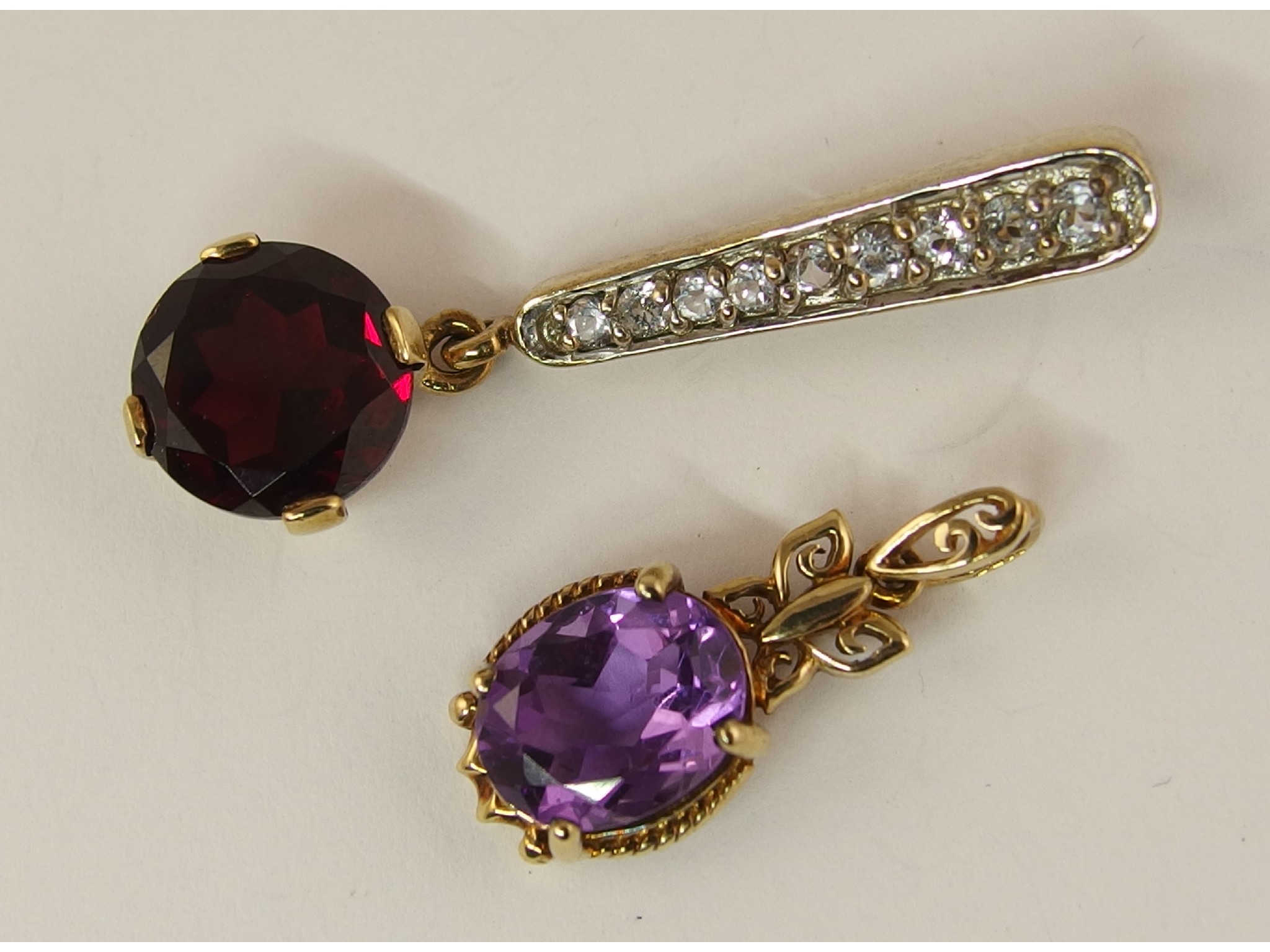 Appraisal: A ct garnet and a ct amethyst pendant