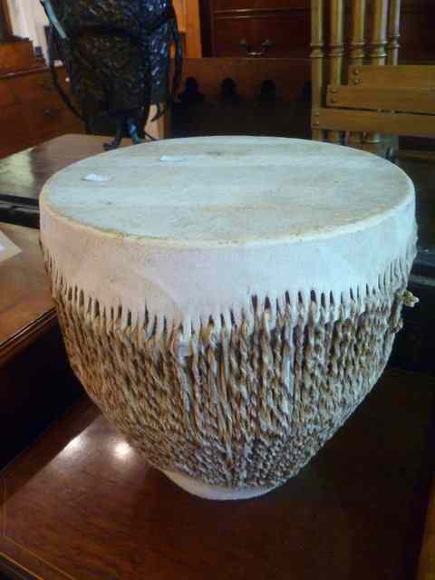 Appraisal: AN AFRICAN HIDE COVERED DRUM of tapering cylindrical form