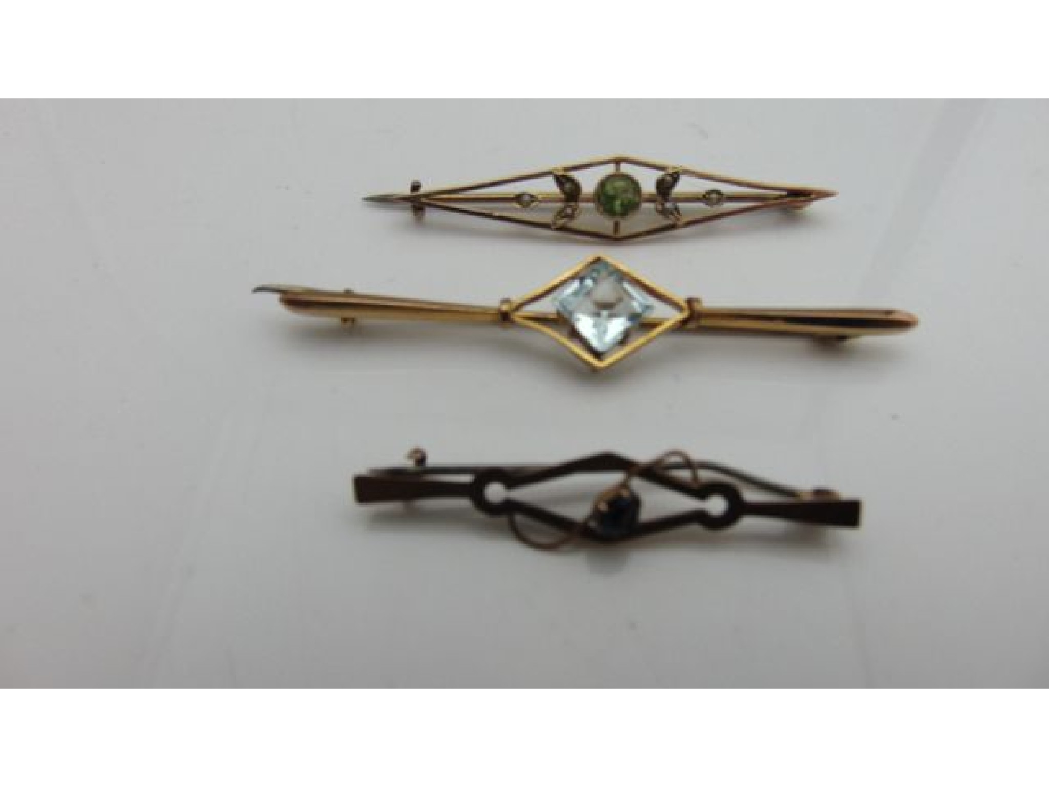 Appraisal: Three early th century gem-set bar brooches in ct gold