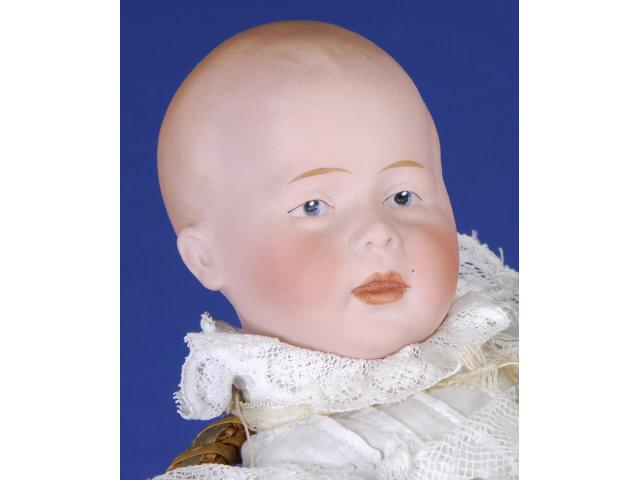 Appraisal: Swaine Co Baby Doll with Wicker Basket Germany ca bisque