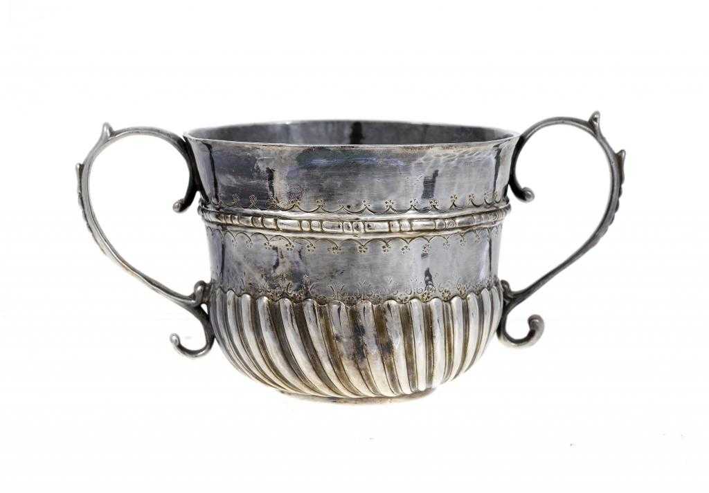 Appraisal: A QUEEN ANNE PORRINGER with embossed girdle and bands of