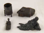 Appraisal: Four various bronzes being an oriental ribbed vesta a humorous