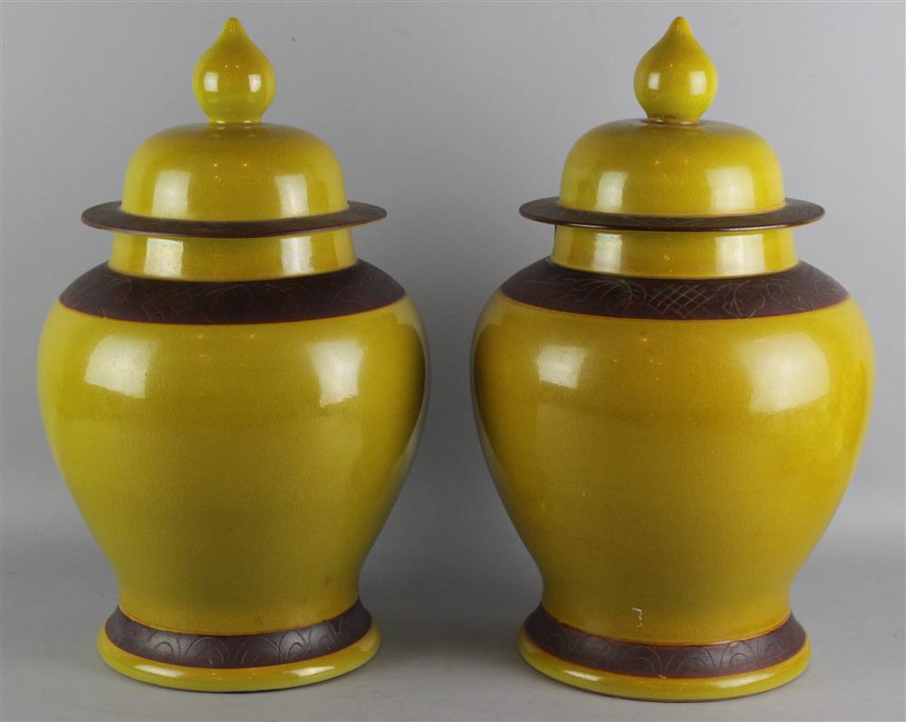 Appraisal: PAIR OF MUSTARD-GLAZED BALUSTER JARS AND COVERS the high shouldered