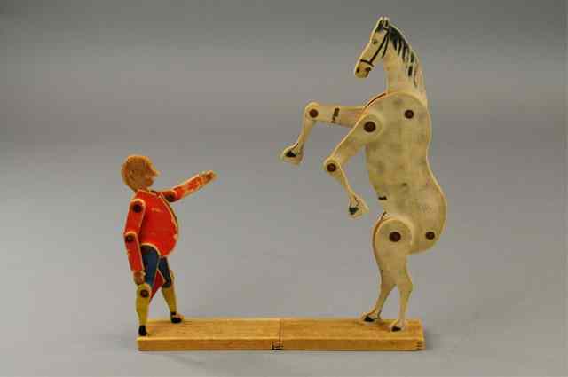 Appraisal: CRANDALL'S DONKEY AND MAN TOY Made of wood articulated legs