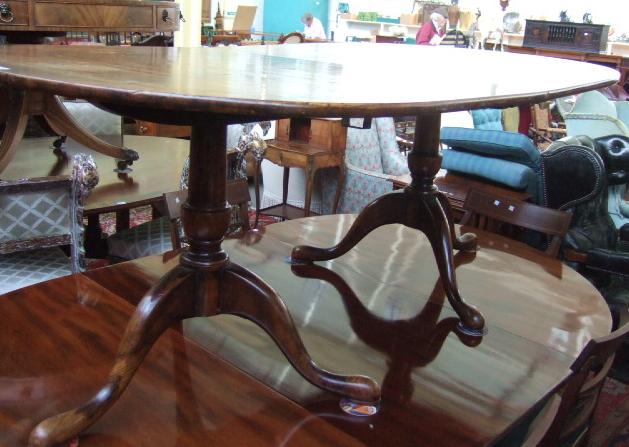 Appraisal: A Regency style walnut dining table the cross banded top