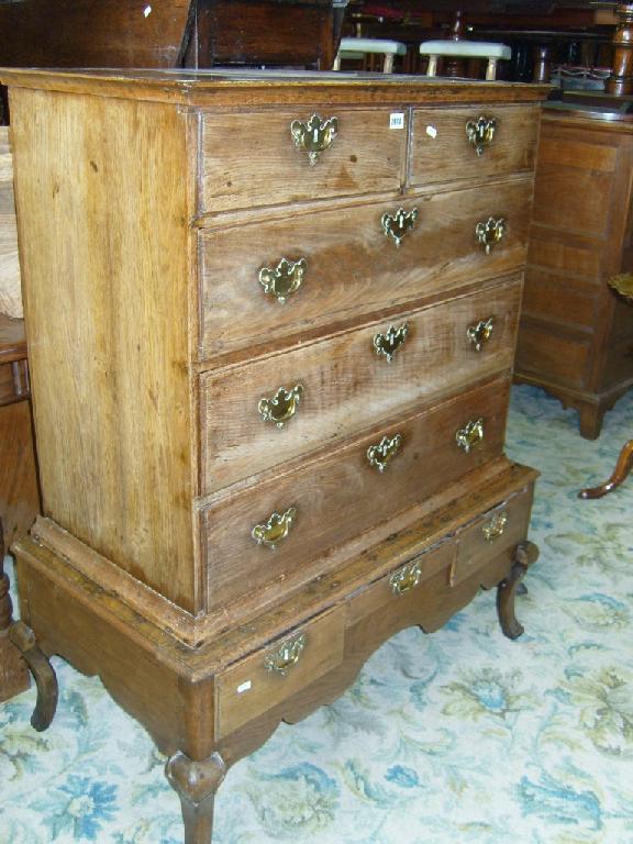 Appraisal: A Georgian oak chest on stand with long and short