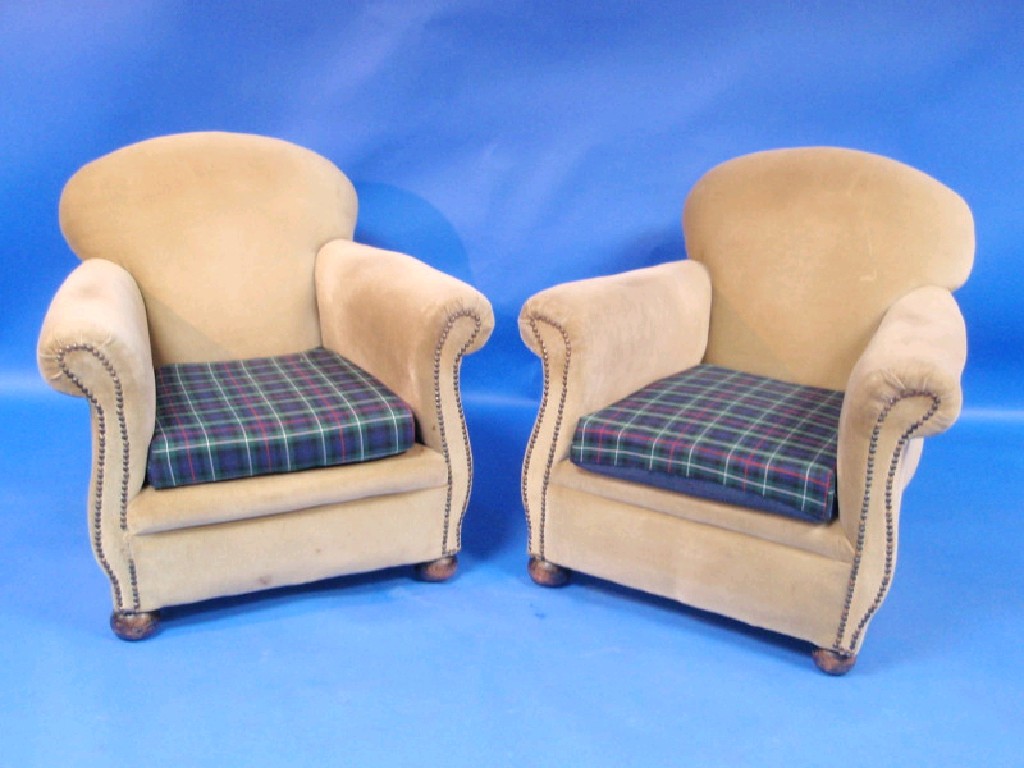 Appraisal: A pair of thC club-style upholstered armchairs on turned bun