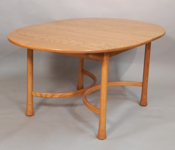 Appraisal: A modern Ercol light elm extending dining table the oval