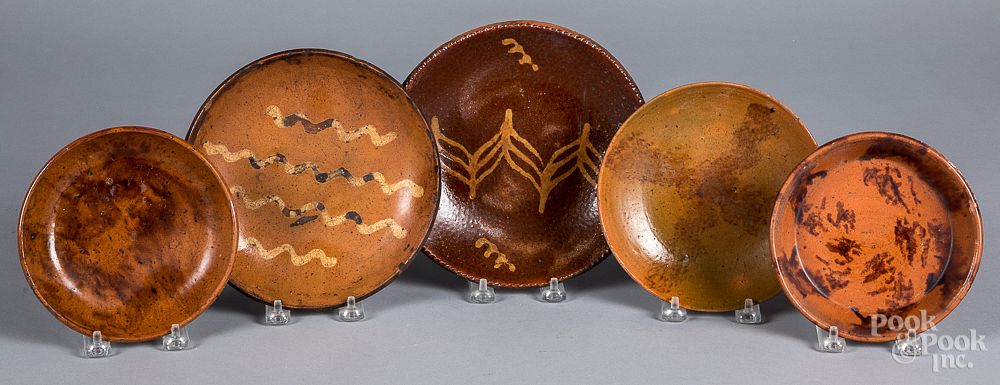 Appraisal: Five redware plates and shallow dishes th c Five redware