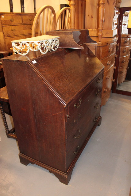 Appraisal: A GEORGIAN OAK BUREAU the fall front enclosing a fitted