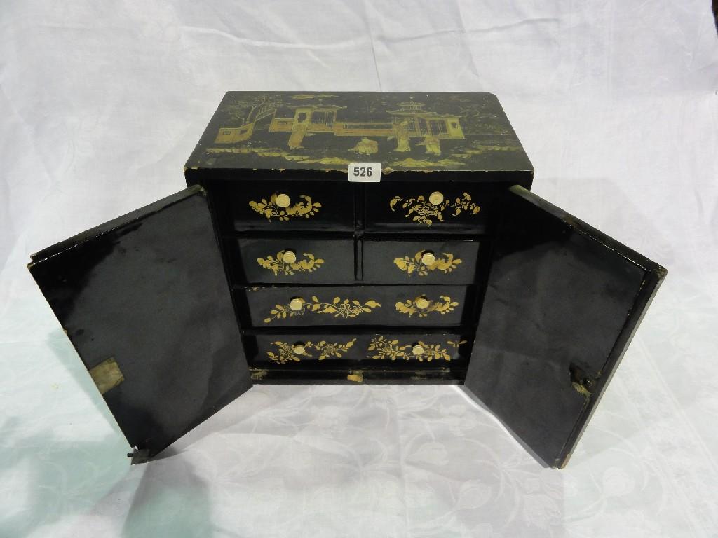 Appraisal: A Japanese black lacquered cabinet with overall gold chinoiserie pattern