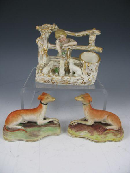 Appraisal: Bisque Figurine Group including a pair of whippets with ear