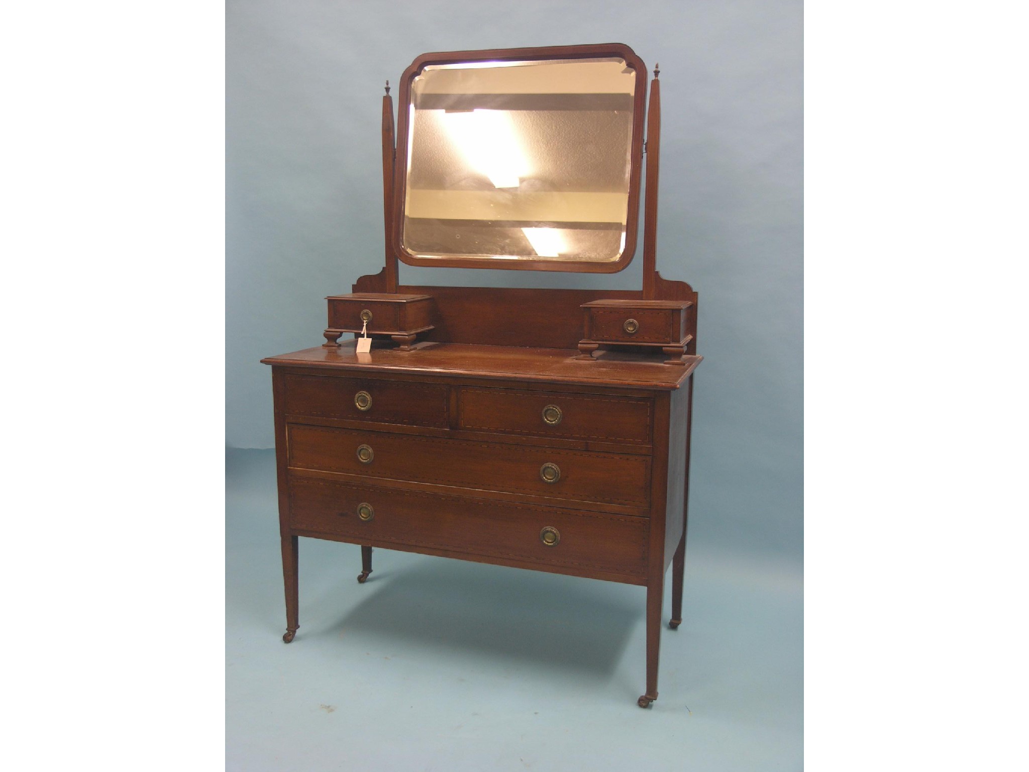 Appraisal: An Edwardian inlaid mahogany dressing chest adjustable bevelled mirror above