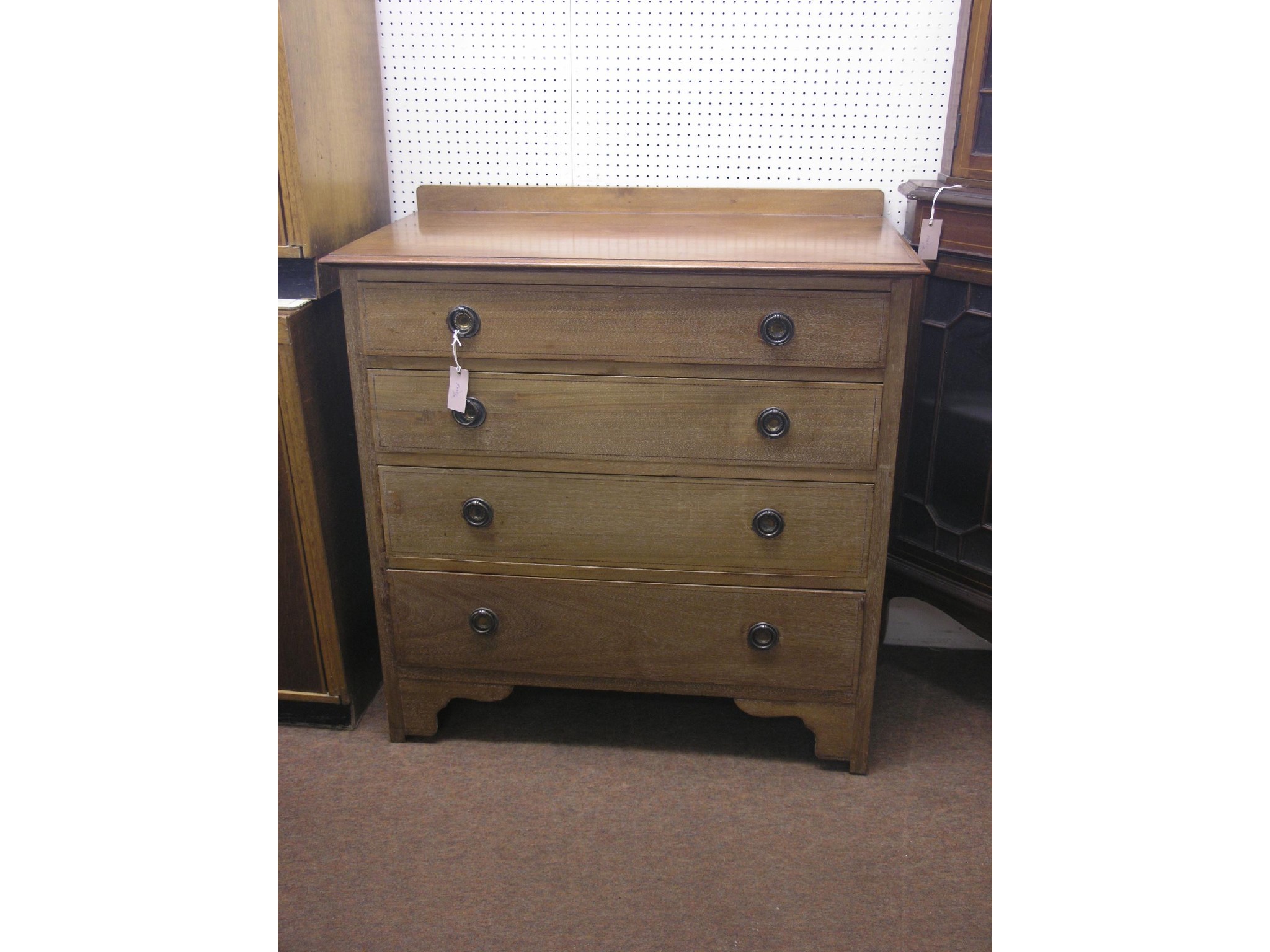 Appraisal: An Edwardian inlaid mahogany chest four graduated drawers with brass