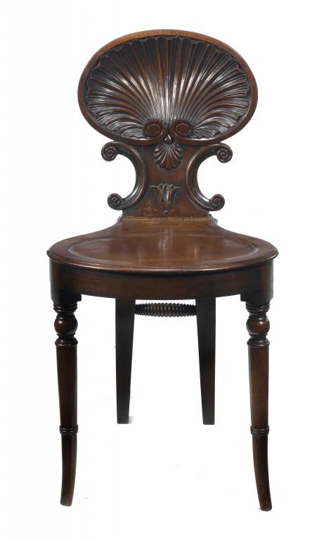 Appraisal: A GEORGE IV MAHOGANY HALL CHAIR with crisply carved scallop