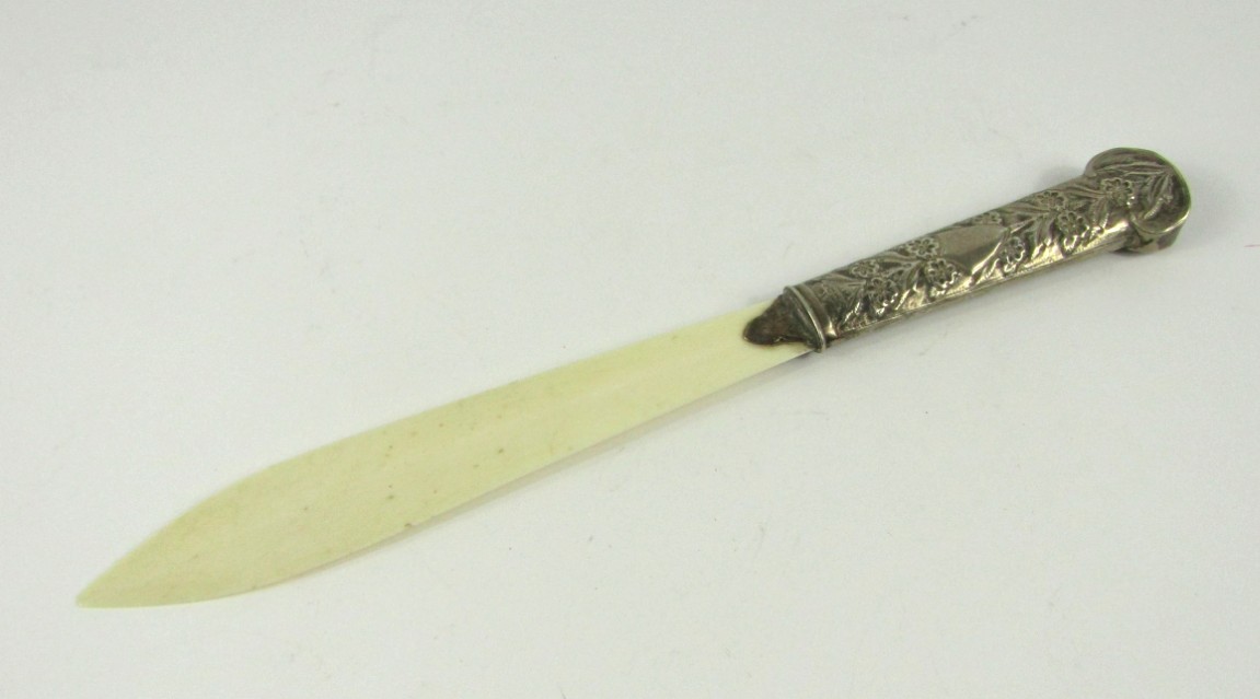 Appraisal: A late Victorian ivory page turner with embossed silver handle