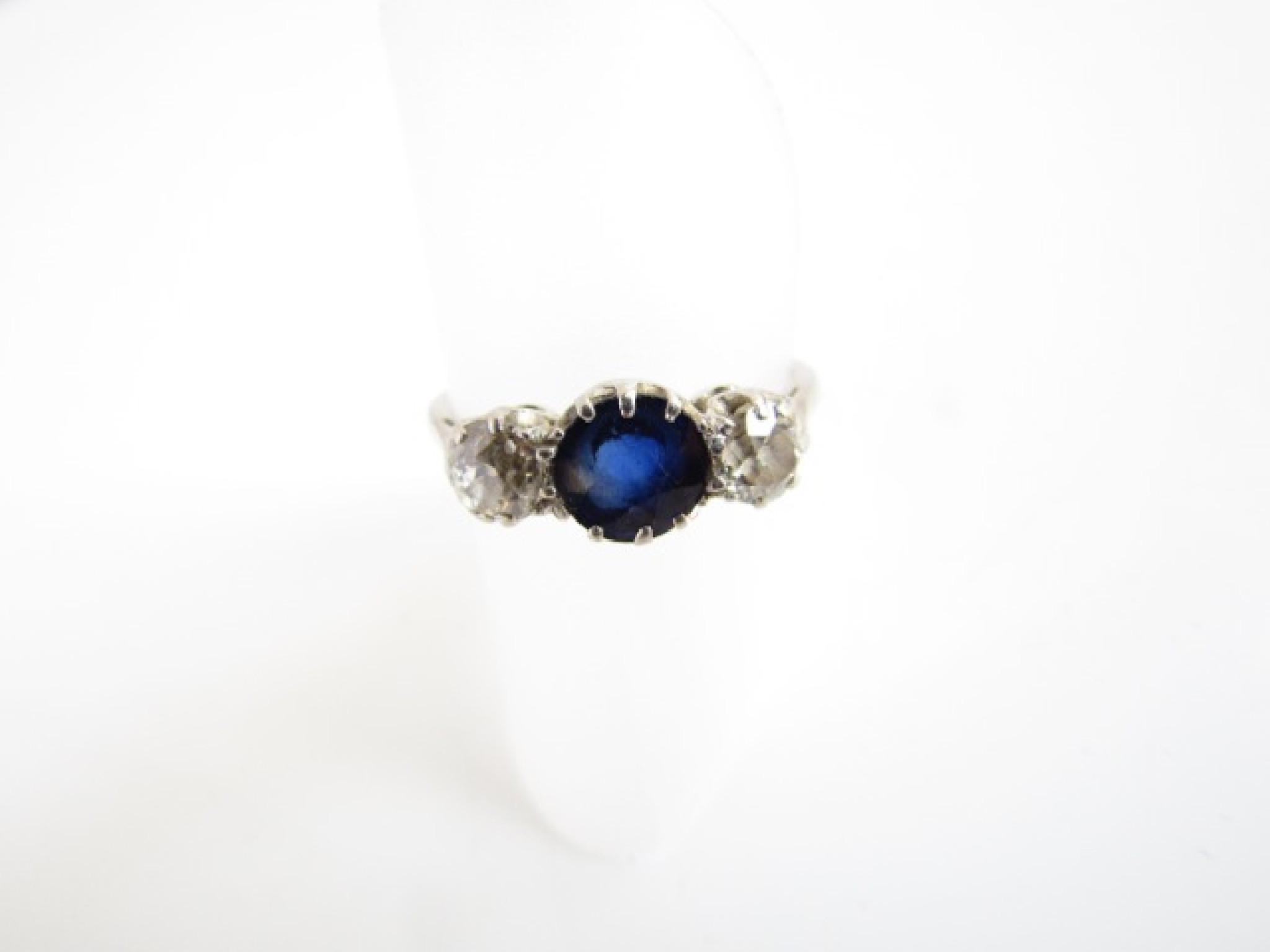 Appraisal: A sapphire and diamond ring centred with a round mixed-cut