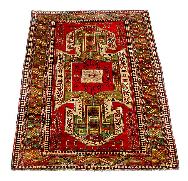 Appraisal: A RED GROUND KAZAK DESIGN RUG with large central geometric