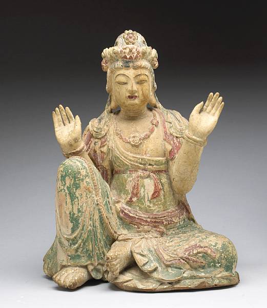 Appraisal: A painted wood figure of a seated Guanyin th Century