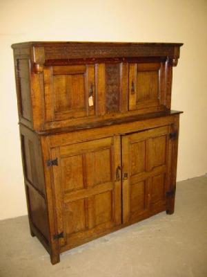 Appraisal: AN OAK COURT CUPBOARD the carved overhanging frieze with turned