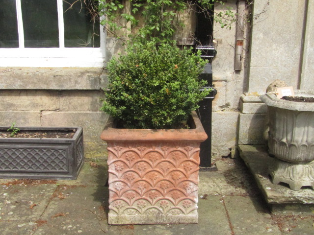 Appraisal: A pair of terracotta square planters decorated with floral scale