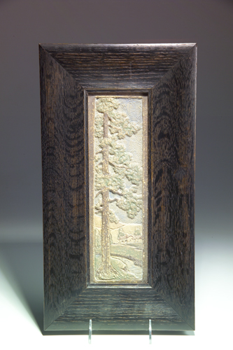 Appraisal: CLAYCRAFT Tall and narrow panel modeled with a pine tree