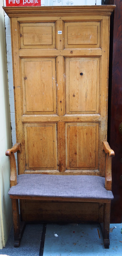 Appraisal: A th century pine open arm hall bench with high