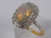 Appraisal: A yellow metal tests carat gold opal and diamond ring