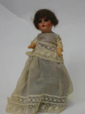 Appraisal: A Heubach bisque head girl doll with blue glass sleeping