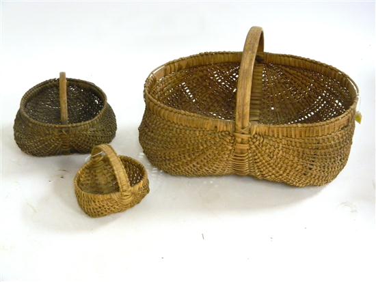 Appraisal: Three woven buttocks baskets with arch handles minor loss largest