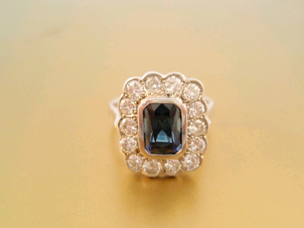 Appraisal: A rectangular sapphire and diamond cluster dress ring the central