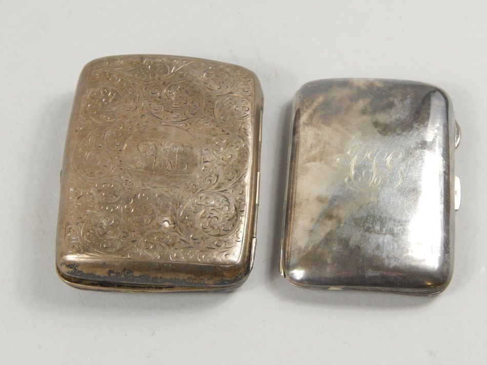 Appraisal: Two silver cigarette cases one with engraved scrolls etc surrounding