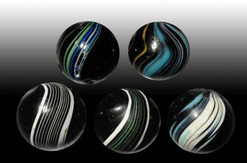 Appraisal: Lot of Indian Swirl Marbles Description Includes two precision-banded Indians