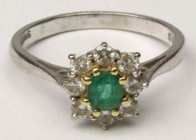 Appraisal: An emerald and diamond cluster ring set in ct white