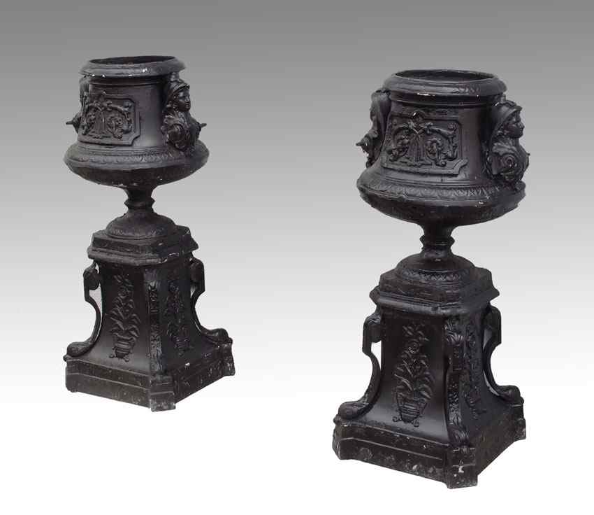 Appraisal: PAIR OF CAST IRON PLANTERS Decorated with masquerons and floral