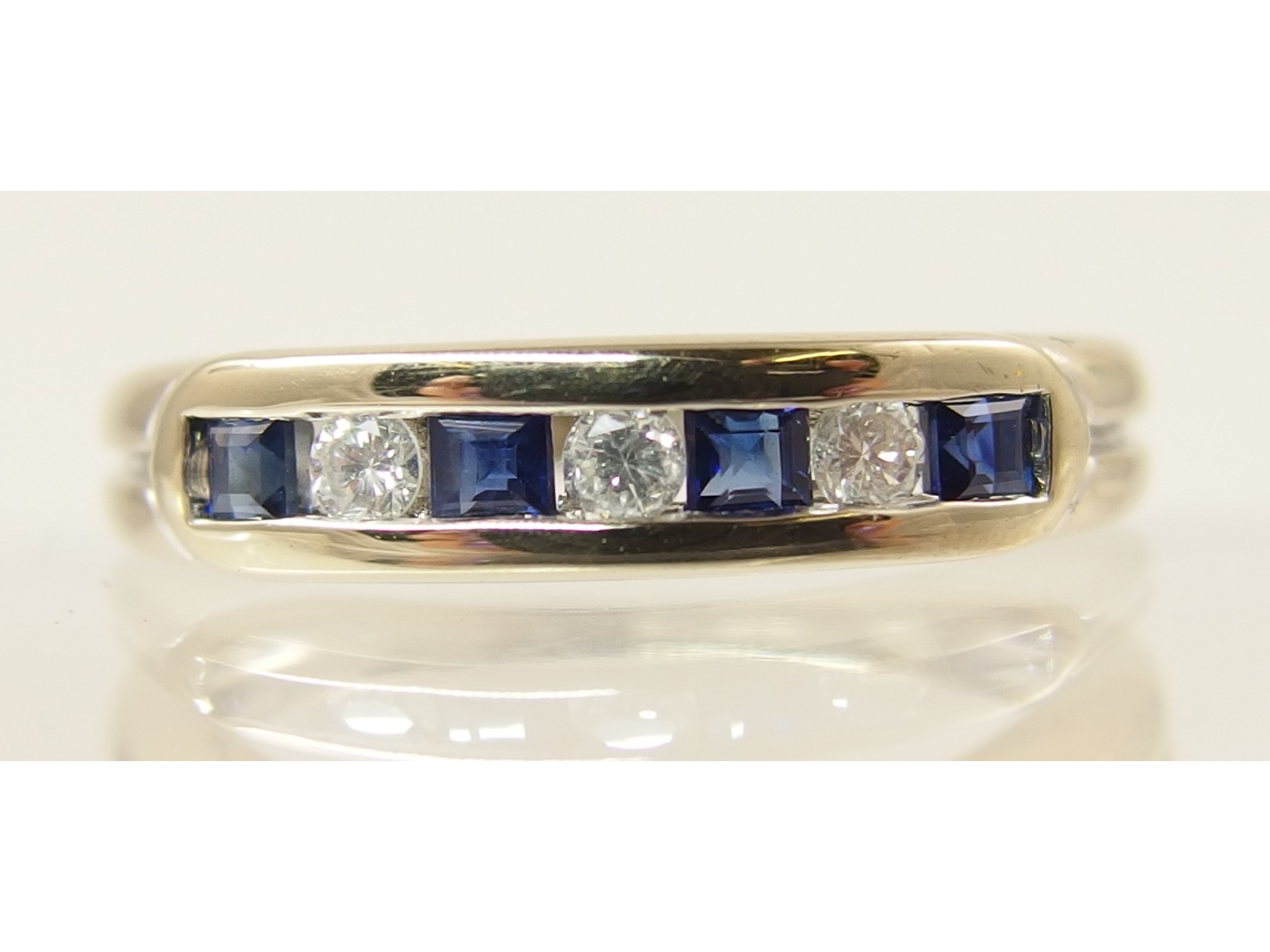 Appraisal: An ct diamond and sapphire half hoop ring