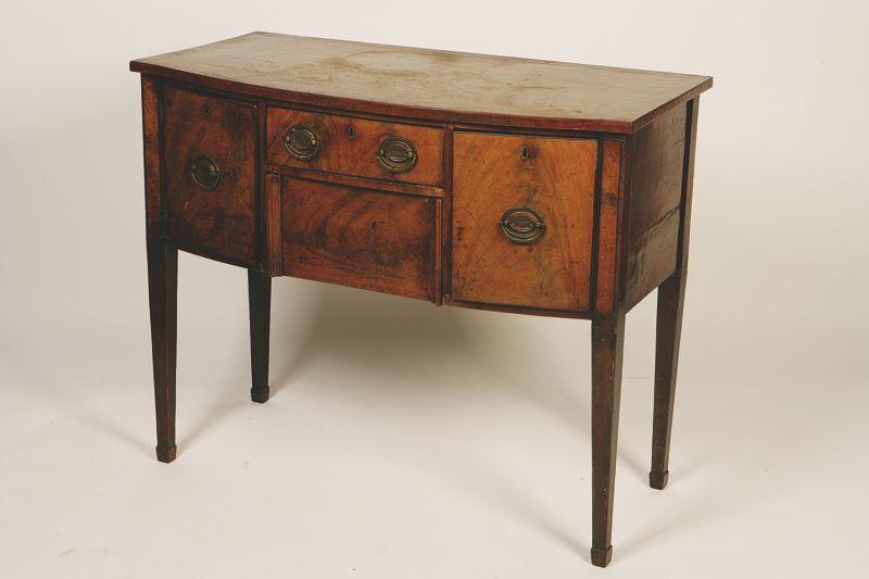 Appraisal: A GEORGE III MAHOGANY BOW FRONT SIDEBOARD the shaped top