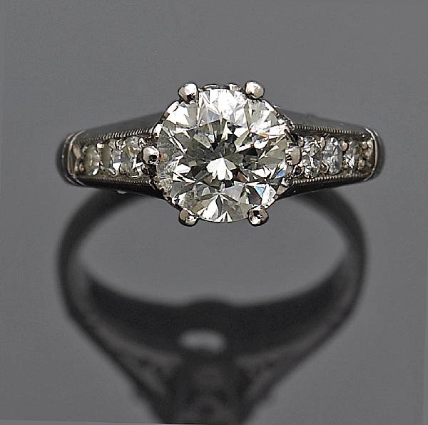 Appraisal: A diamond ring centering a transitional round brilliant-cut diamond weighing