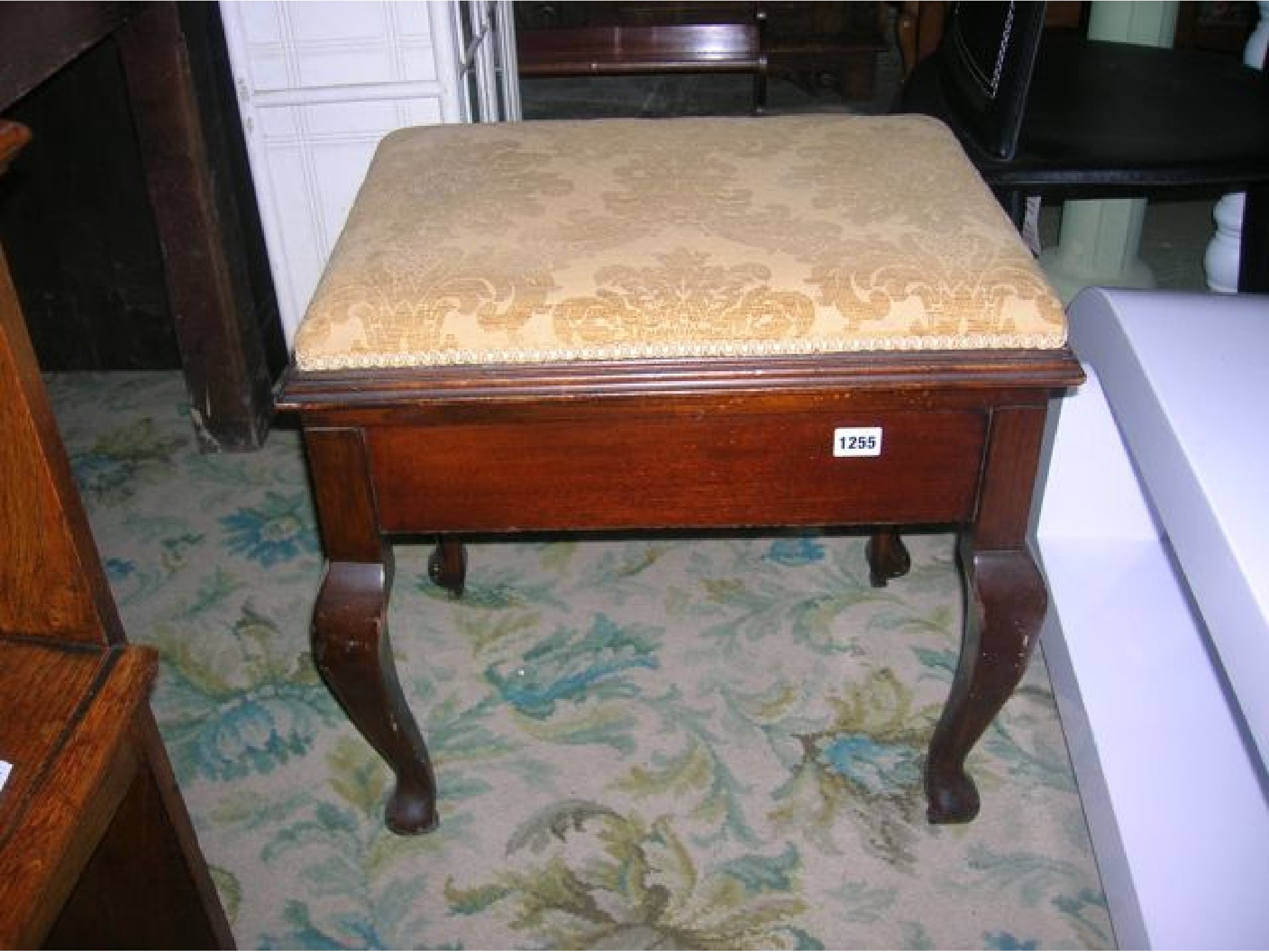 Appraisal: An Edwardian mahogany piano stool of rectangular form with upholstered