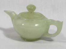 Appraisal: A miniature tea pot carved in green hardstone