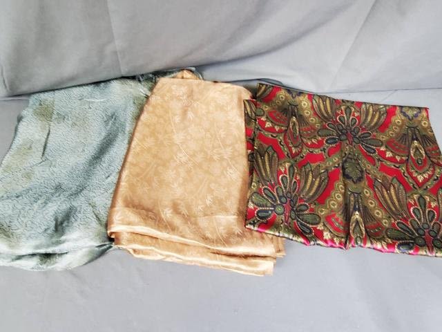 Appraisal: Three pieces of vintage fabric including a green silk measuring