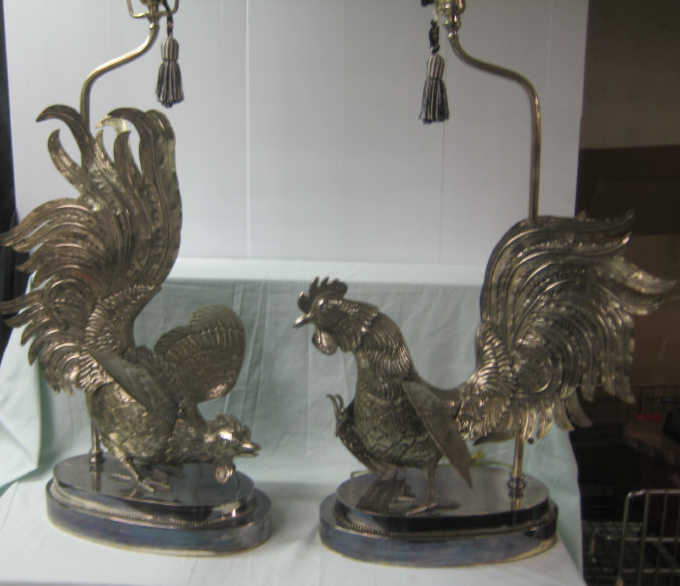 Appraisal: PAIR OF SILVERED METAL FIGHTING COCKS Supported on stepping oval