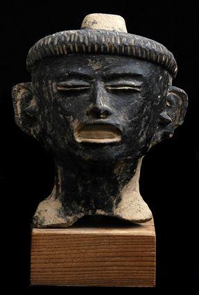 Appraisal: PRE-COLUMBIAN BLACK-GLAZED TERRACOTTA HEAD On base in Provenance Property from