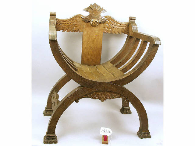 Appraisal: European oak chair with carved spread wings splat and Roman