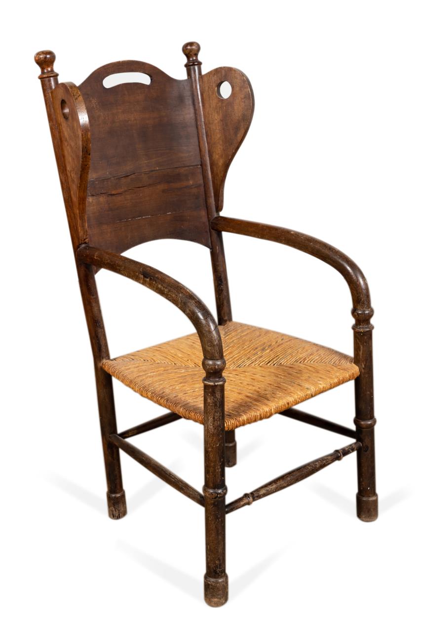 Appraisal: PRIMITIVE PINE WINGBACK CHAIR WITH RUSH SEAT Primitive pine wingback